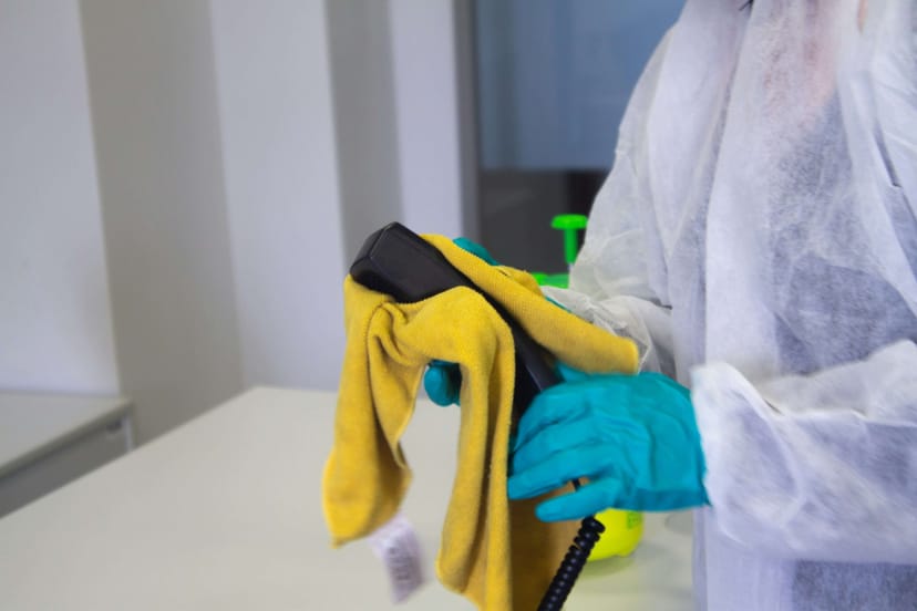 A phone and table cleaned as part of a spring cleaning service